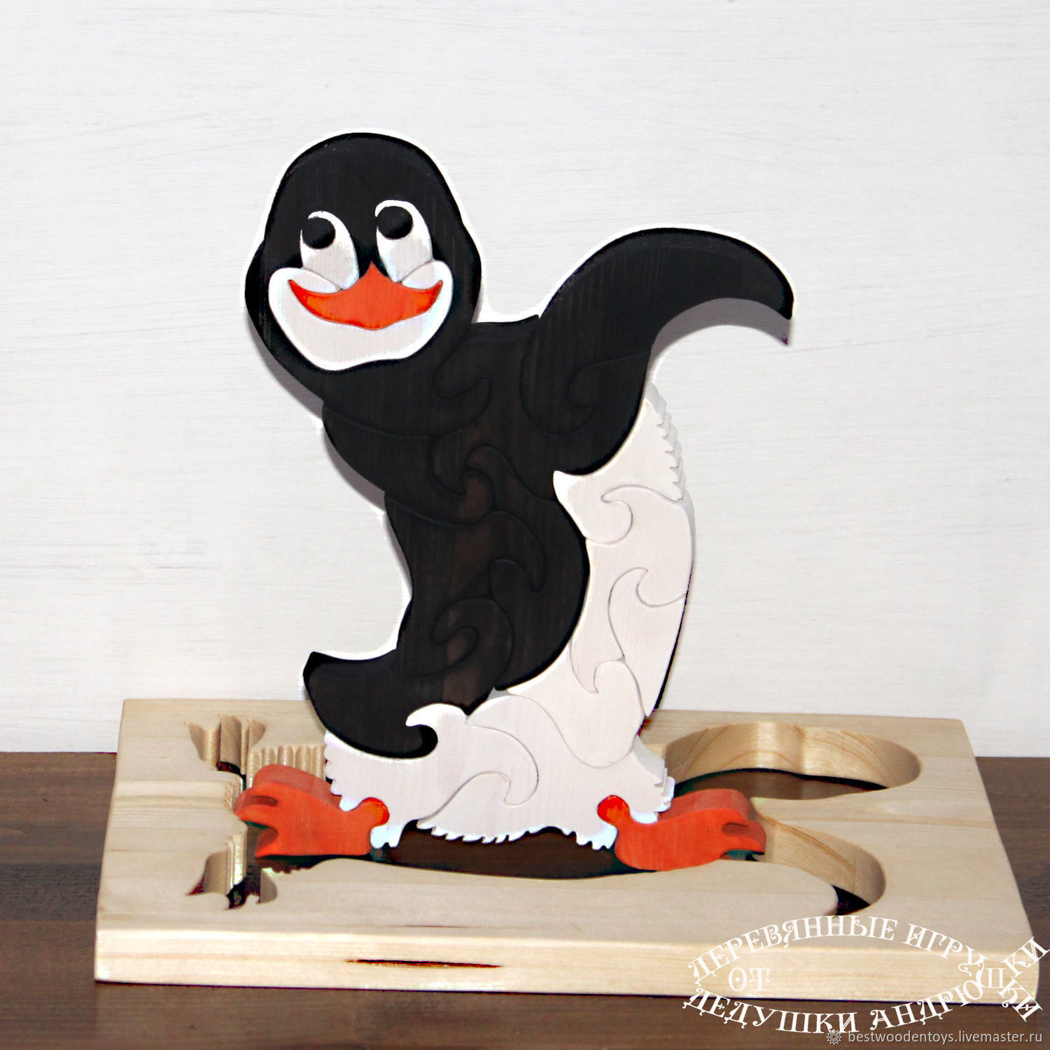 Gift under the Christmas tree. Puzzles of wood Penguin `Dance!?`. Wooden toys from Grandpa Andrewski.
