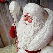 Santa Claus with bullfinches toy under the Christmas tree as a child made of cotton wool