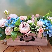 Mini garden of artificial flowers in a basket