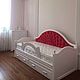 Cozy children's bed with upholstered headboard. Has a removable fence for child safety. At the bottom of the bed there are two roll-out drawers for storage. The difference in color,size, materials is 