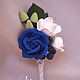 Boutonniere with blue rose, freesia and blueberries  
