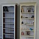 Tall bookcase with six open shelves. Decorative flutings and a scalloped frame under the eaves.