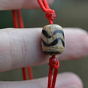Фен-шуй и эзотерика handmade. Livemaster - original item Amulet with a Ji bead on a red cord, Tibetan miniature bead. Handmade.