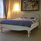 Bed with soft headboard, made in the style of Chester, framed by a carved frame. The carved and gilded and as well decorate the legs and side bars products.