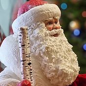 Santa Claus is a traditional figurehead under the Christmas tree made of cotton wool