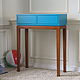 A high console on oak legs. The blue top has two roomy drawers. The difference in color, size is possible with hand work. The product is created for a modern interior.
