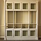 A beautiful Cabinet with glass façades and Windows. On top of the Cabinet is framed with beautiful decorative cornice. the difference in color, sizes and materials possible through manual work.
