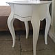 Bedside table on graceful curved legs, scalloped top.  
