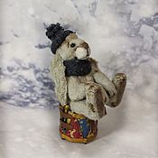 Snowman in a hat with earflaps a small Christmas gift
