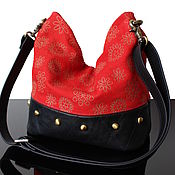 Red leather handbag quilted on the clasp