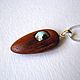 Pendant for sale.
Wooden pendant with turquoise