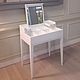 White vanity table with folding mirror and compartments to store. Strict straight lines, bevel mirror, give the table elegance and conciseness.
