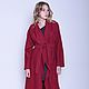 The brilliant design of the coat of wool of loden clothes on a warm demi-season. Color red shade of cranberry; asymmetrical hem; fitted silhouette; wide Raglan sleeves; soft shawl collar.
