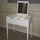 White vanity table with folding mirror and compartments to store. Strict straight lines, bevel mirror, give the table elegance and conciseness.
