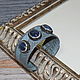Leather bracelet reptile on a metal basis is decorated with natural kyanite surrounded by crystals rhinestone and marcasite
