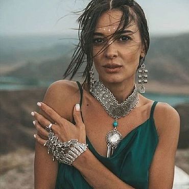 woman accessorizing with bold jewelry